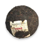 Tamsūs fermentuoti Pu-erh arbatos lapeliai su įspausta XiaGuan etikete
